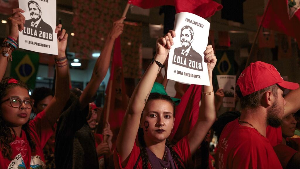 Supporters of former Brazilian president Luiz Inácio Lula da Silva hold signs during the supreme court’s sentence ruling in São Bernardo do Campo. Photograph: Patricia Monteiro/Bloomberg
