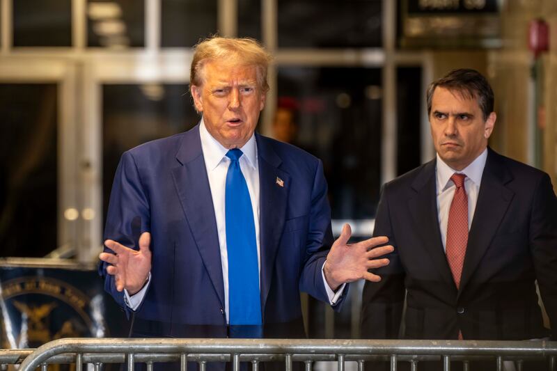 Donald Trump speaks to the media along his attorney Todd Blanche at Manhattan Criminal Court on Friday. Photograph: Mark Peterson/Pool/Getty Images