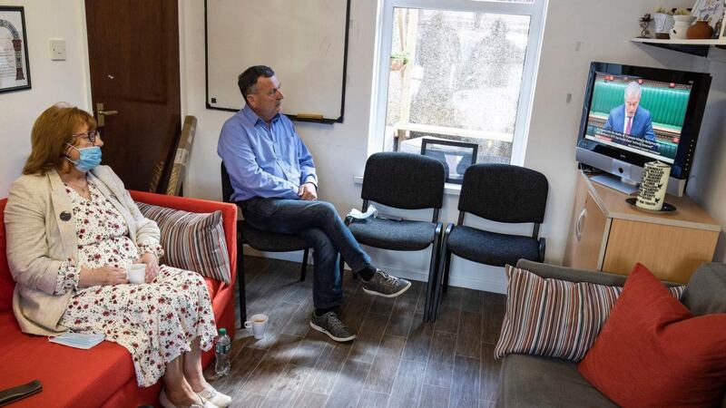 Briege Voyle, daughter of Joan Connolly, and John Teggart, son of Daniel Teggart, sit together at Springhill Community House to watch Northern Ireland Secretary Brandon Lewis make a statement on Ballymurphy to the House of Commons. Photograph: Brian Lawless/PA Wire