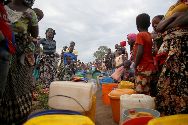 Women and girls queue for water after MSF trucked 8,000 litres of water to an open space on the outskirts of Mueda, a town in the northern Mozambican province of Cabo Delgado, where displaced people have been temporarily relocated by the authorities. Photograph: Igor Barbero/MSF