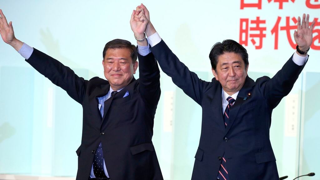 Shinzo Abe, right, with former defence minister Shigeru Ishiba after the ruling party presidential elections at its headquarters in Tokyo on Thursday. Photograph: Koji Sasahara/AP