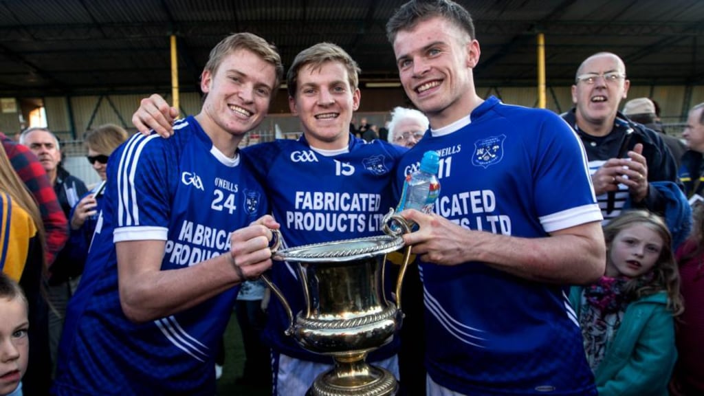 Cratloe’s brothers David, Padraic and Sean  Collins  celebrate with the Clare senior football championship trophy. Photograph: James Crombie/Inpho.