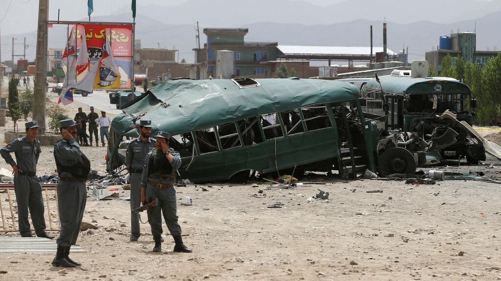 Afghan security forces inspect the damage on buses hit by suicide bombers at the site of an attack on the western outskirts of Kabul, Afghanistan on Thursday. Photograph: Omar Sobhani/Reuters
