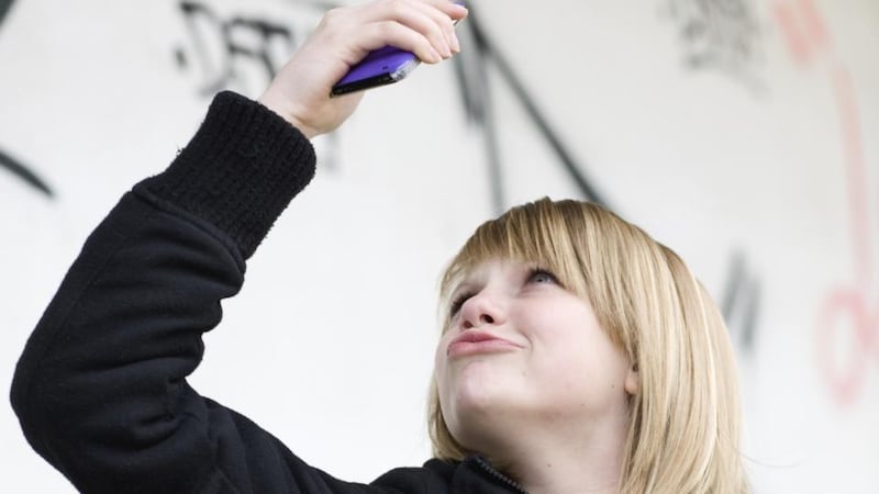 The selfie: a YouTube tutorial on the subject advises self-portraitists to hold their necks out, duck-like, angle their heads and lift the camera above their heads for that ‘baby-face look’. Photograph: Thinkstock