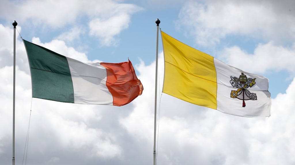 Irish and papal flags: Church Street residents have received a flier telling them they need to give gardaí the names of all those expected to be at their home on Saturday. Photograph: Niall Carson/PA