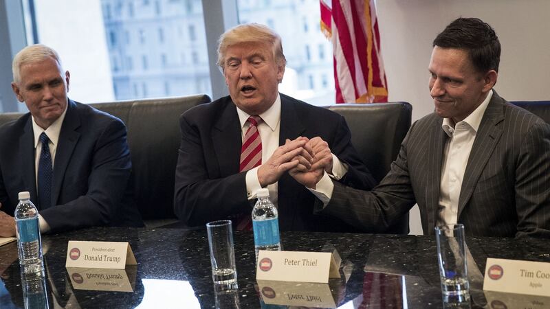 Then vice president-elect Mike Pence looks on as president-elect Donald Trump shakes the hand of Peter Thiel at Trump Tower, December 2016. Photograph: Drew Angerer/Getty