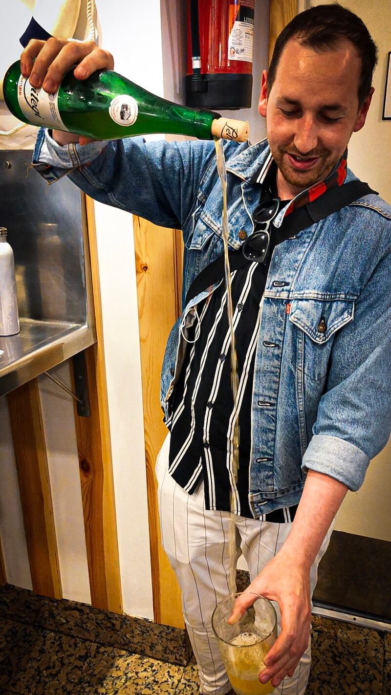 Patrick Hanlon pouring a glass of Txakoli (sparkling wine)