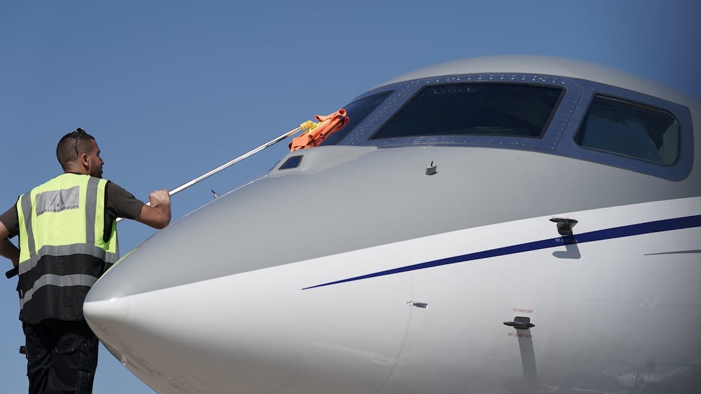 A worker cleans the cockpit windows of a Bombardier Global 7500 long range business jet. Photograph: Jasper Juinen/Bloomberg