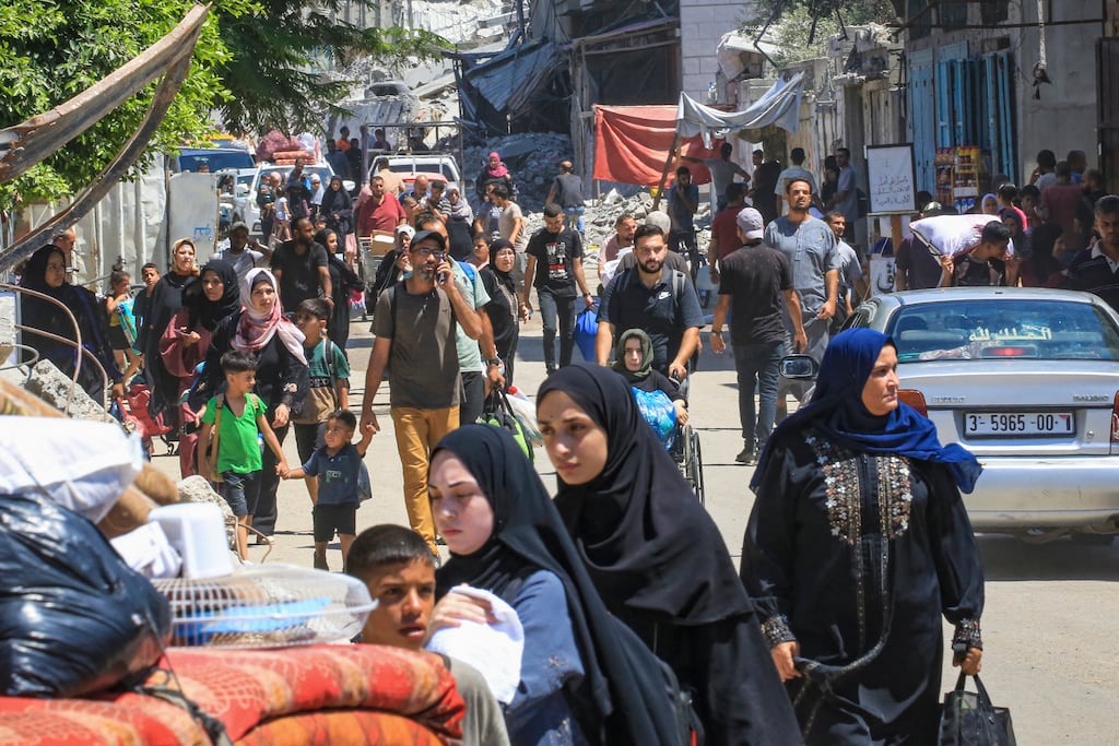 People flee the al-Bureij refugee camp in the central Gaza Strip following Israeli bombardment on Tuesday. Photograph: Eyad Baba/AFP via Getty Images