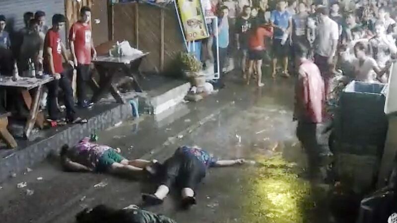 A still image from a CCTV video shows British man Lewis Owen and his parents on the ground after they were attacked during a family vacation in Thailand. Photograph: AP