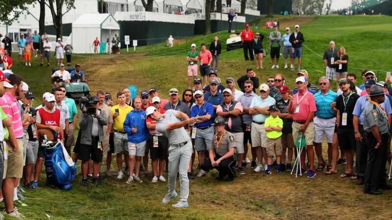 Rory McIlroy plays a shot from the rough on the 18th hole. Photo: Rob Carr/Getty Images
