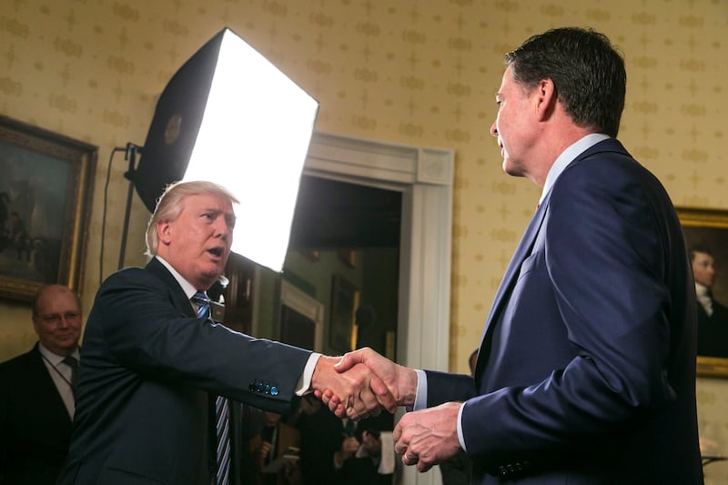 US president Donald Trump shakes hands with James Comey, then FBI director, at the White House in 2017. Photograph: Al Drago/New York Times