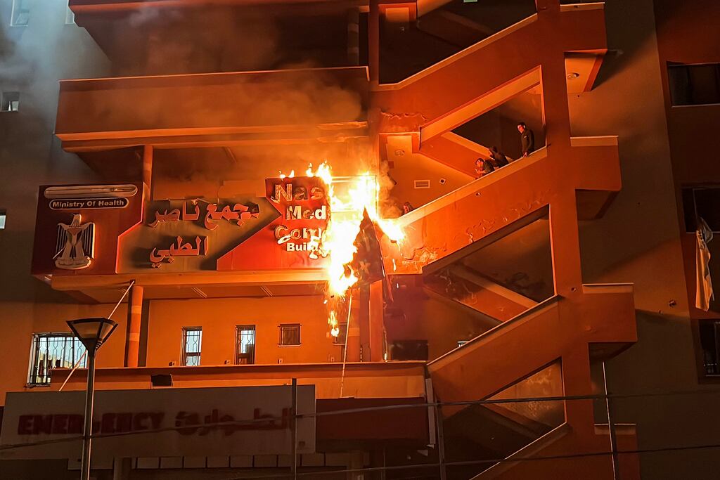 Palestinians attempt to extinguish a fire at the emergency department of the Nasser hospital in the southern Gaza Strip after it was hit in an Israeli air strike on Sunday. Photograph: AFP via Getty Images