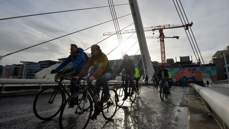 Protesters cycle across the Samuel Beckett Bridge over the Liffey on Sunday morning. Photograph: Alan Betson