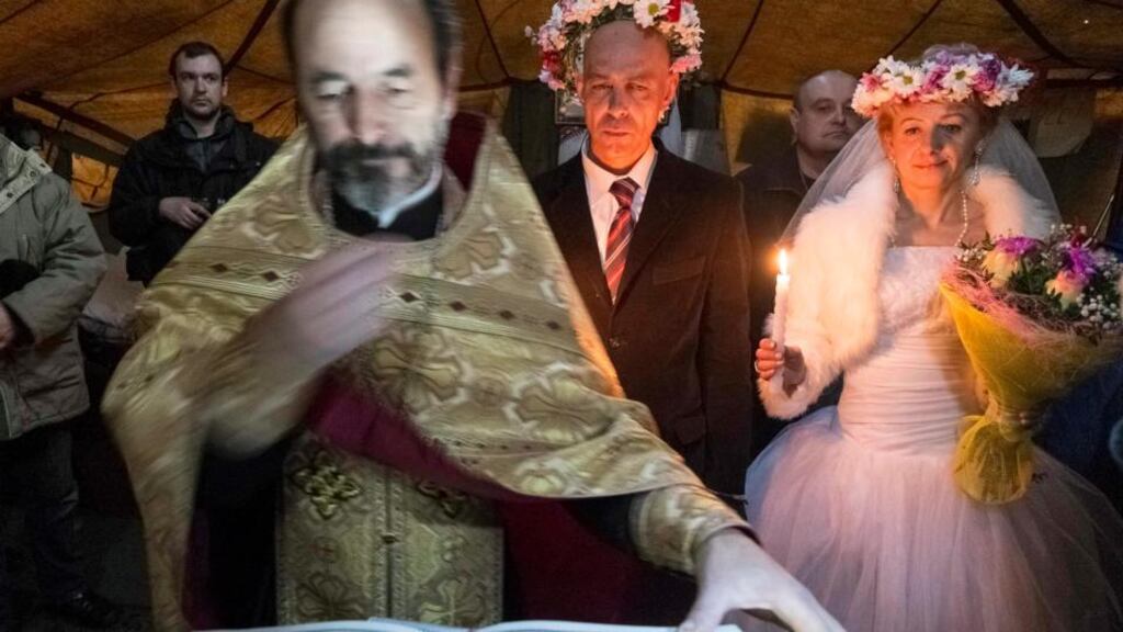 Ukrainian anti-government protesters Oleksandr and Halyna get married inside a makeshift tent chapel at Independence Square in Kiev yesterday. Photograph: Reuters/Gleb Garanich