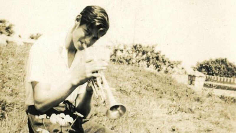 Ivor Browne playing the trumpet in the field beside the family home in Sandycove: he was heavily influenced by his passion for music and the arts.