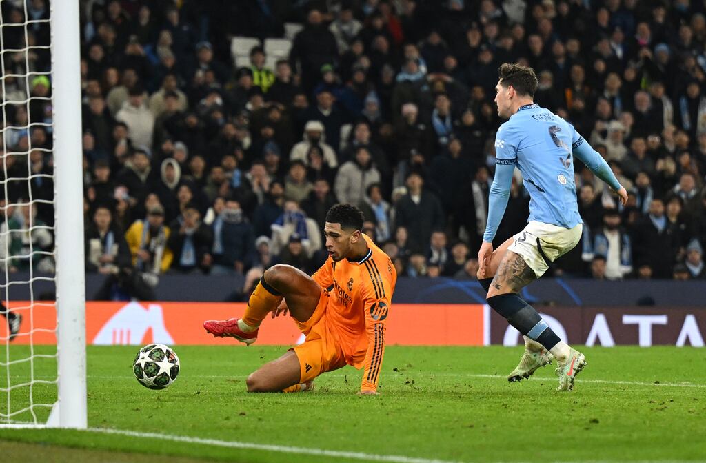 Jude Bellingham scores Real Madrid's third goal under pressure from Man City's John Stones. Photograph: Michael Regan/Getty Images