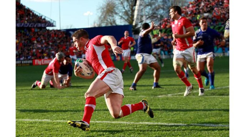 Wales's Shane Williams runs in a try during their Pool D match against Samoa at the Waikato Stadium, Hamilton, New Zealand. - (Photograph: David Davies/PA Wire)