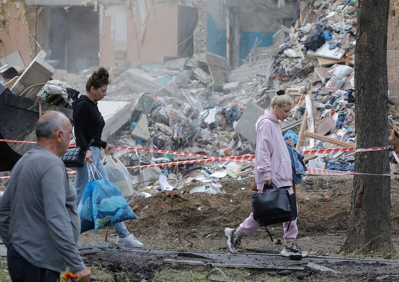 Residents carry their belongings after their flats were severely damaged by a rocket strike on Kyiv in June. Photograph: Sergey Dolzhenko/EPA