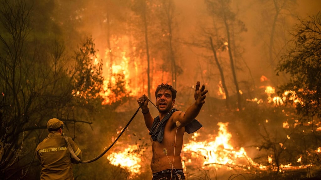A local resident joins the attempt to fight wildfires approaching the village of Pefki on Evia (Euboea) island, Greece’s second largest island. We have been gently boiling our planet and the evidence is all around us. Photograph: Angelos Tzortzinis/AFP/Getty Images
