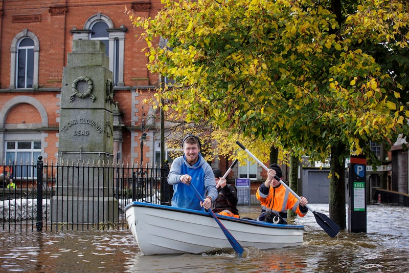 People canoe down a flooded Bank Parade in Newry town, Co Down. Flooding was reported in parts of Northern Ireland, with police cautioning people against travelling due to an amber rain warning. Photo: PA