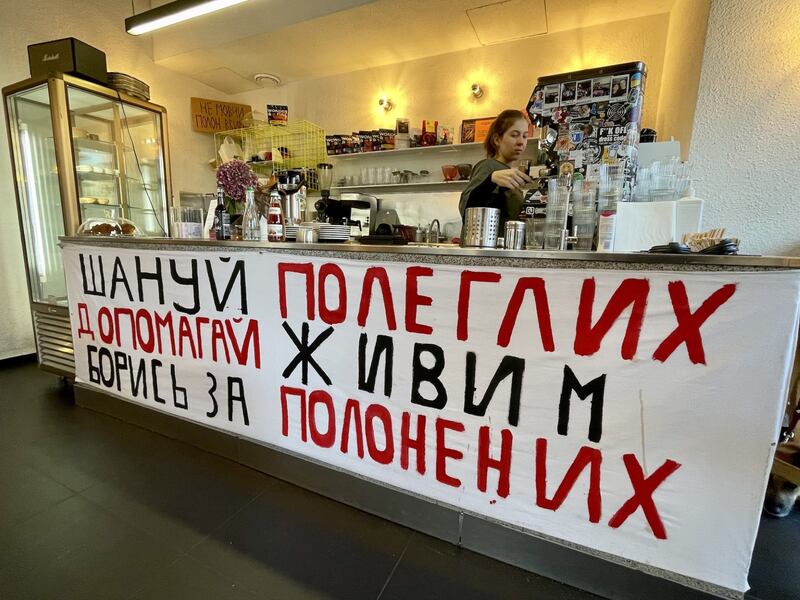 A banner on the counter in a cafe in Lviv in western Ukraine reads: "Respect the fallen. Help the living. Fight for prisoners of war". Photograph: Daniel McLaughlin