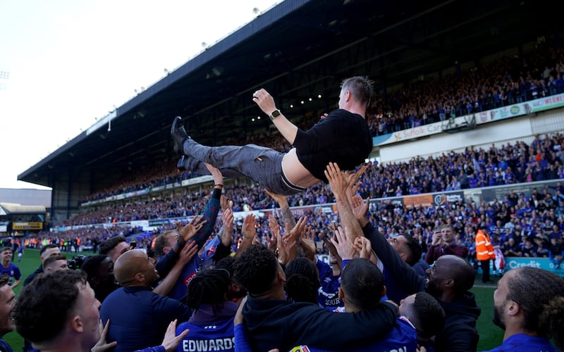 Kieran McKenna is thrown into the air by the players as they celebrate Ipswich's promotion to The Championship from League One at the end of the 2022/23 season at Portman Road. Photograph: Joe Giddens/PA