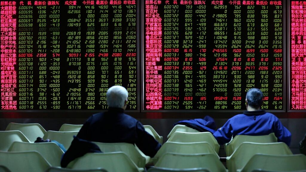 Chinese investors look at a screen showing stock movements at a stock brokerage house in Beijing. Photograph: EPA/How Hwee Young