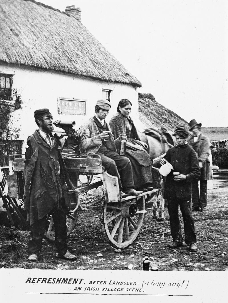 Drinkers featured in ‘an Irish village scene’, dated between 1890 and 1910. Photograph: National Library of Ireland/ Flickr Commons