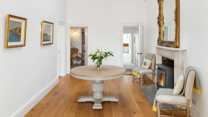 The white walls act as a neutral backdrop for the paintings currently on display