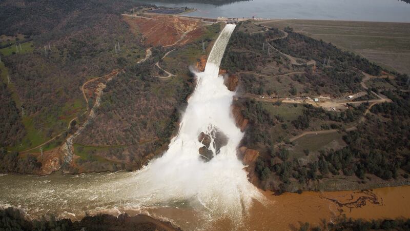 The emergency spillway, and the damaged main spillway, are seen from the air on Monday in Oroville, California. Photograph: Elijah Nouvelage/Getty