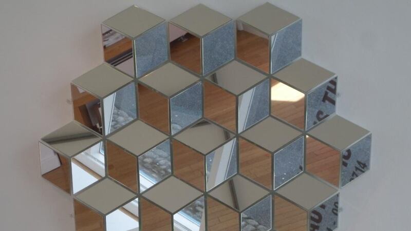 An assembly of angled rhomboidal mirrors by Suresh Dutt