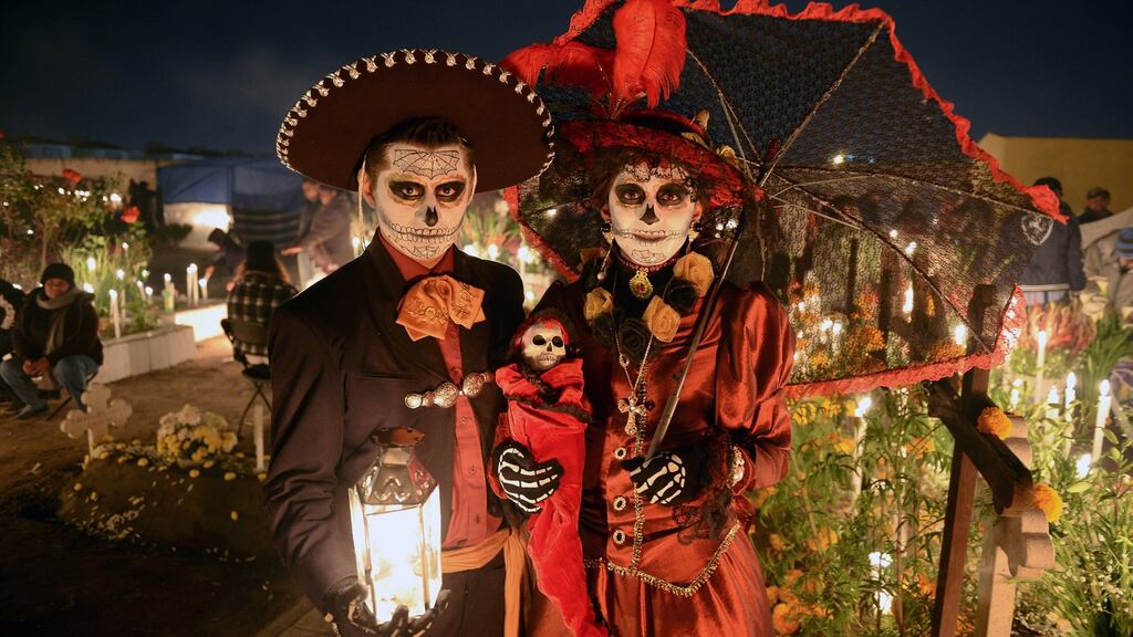 A couple disguised as dead poses at San Jeronimo Chicahualco cemetery in Metepec, Mexico during the commemoration of the Day of the dead. Photograph: Mario Vazquez/AFP/Getty Images