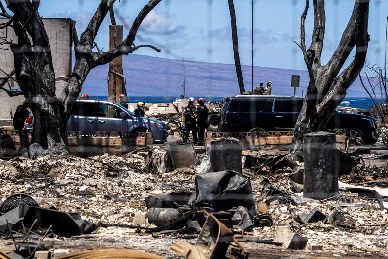 Members of an Urban Search and Rescue Task Force are seen along Front Street destroyed by the West Maui Fire, in Lahaina (Stephen Lam/San Francisco Chronicle via AP)