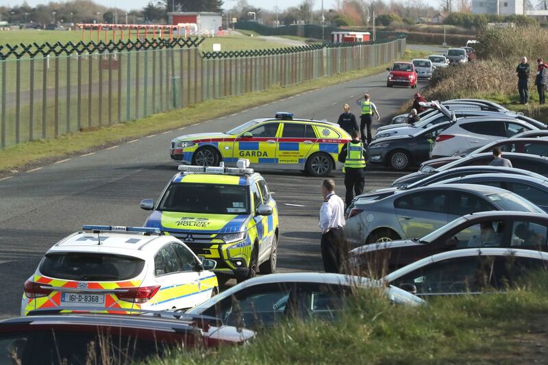 Airport police question motorists at site popular with plane spotters after a confirmed drone sighting forced the temporary suspension of operations at Dublin Airport. Photograph: Nial Carson/PA Wire