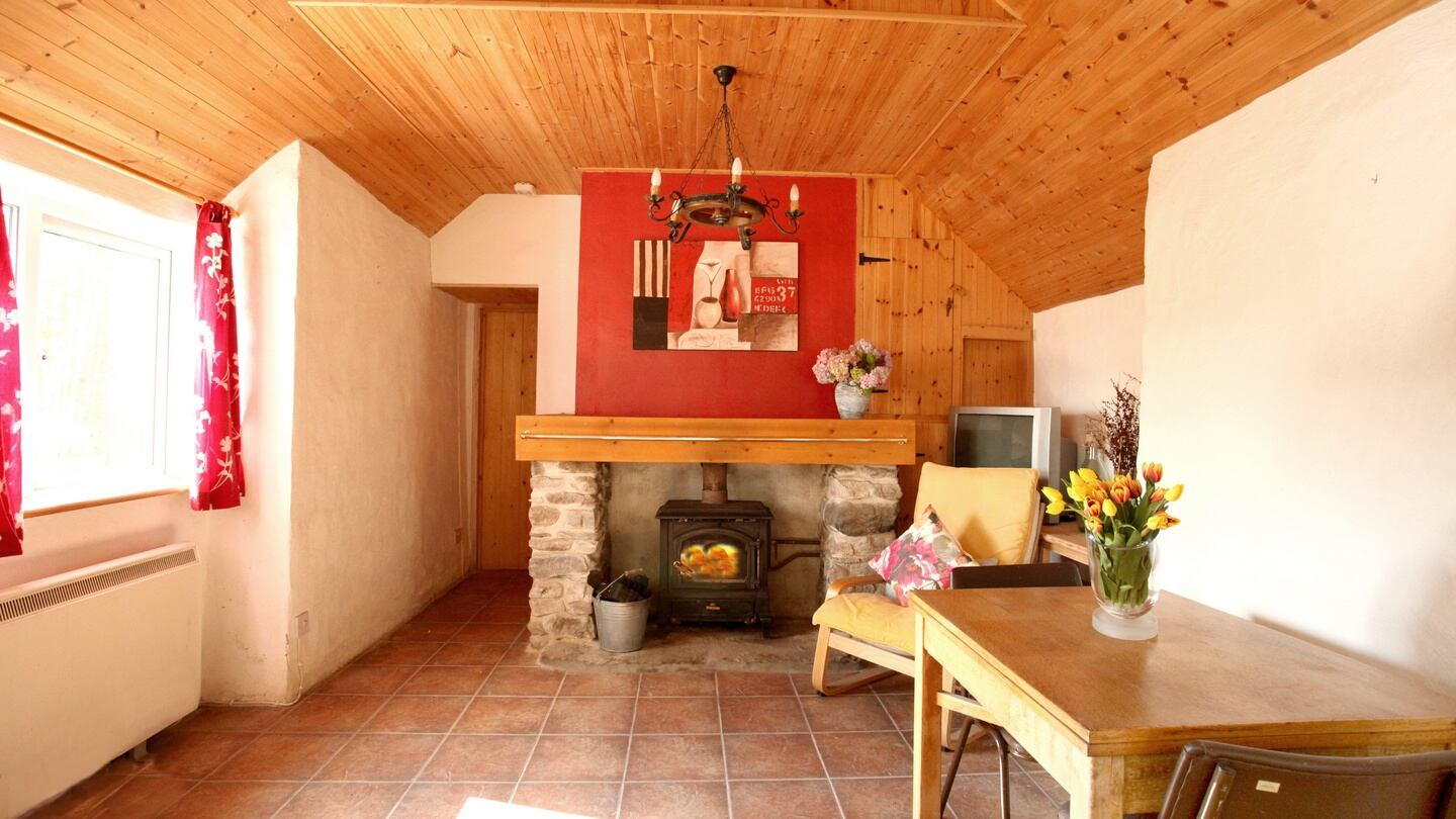The cottage has been upgraded in recent years to include modern comforts such as storage heating and a solid fuel stove