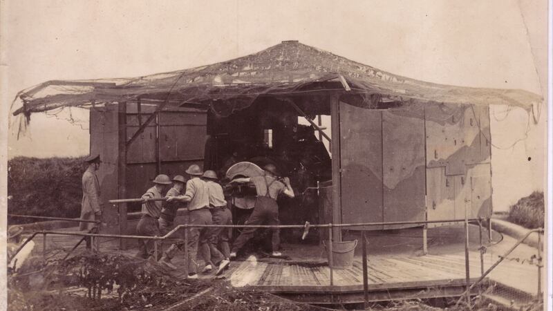 One of the two 9.2-inch BL coastal defence guns at Templebreedy Battery, Crosshaven, Cork, fires during exercises; it is also camouflaged against air attack. These guns had a potential range of almost 27 kilometres. The first had been constructed between 1904 and 1909 to supplement two existing batteries to the north defending Cork Harbour and the naval base at Haulbowline. The battery was handed over to the Defence Forces in 1938 and was largely decommissioned in 1946. (Military Archives)