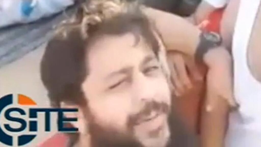 Still from an undated video posted on social media that shows a boy being taunted by several militants before being killed by a man activists identified as a member of the Nour al-Din al-Zinki movement, a rebel group which has received military support channeled from Turkey, including US-made TOW missiles