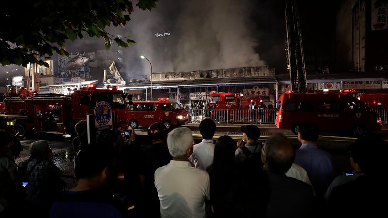 People watch as firefighters try to put out a fire at the Tsukiji market in Tokyo, Japan. Photograph: Kiyoshi Ota/EPA