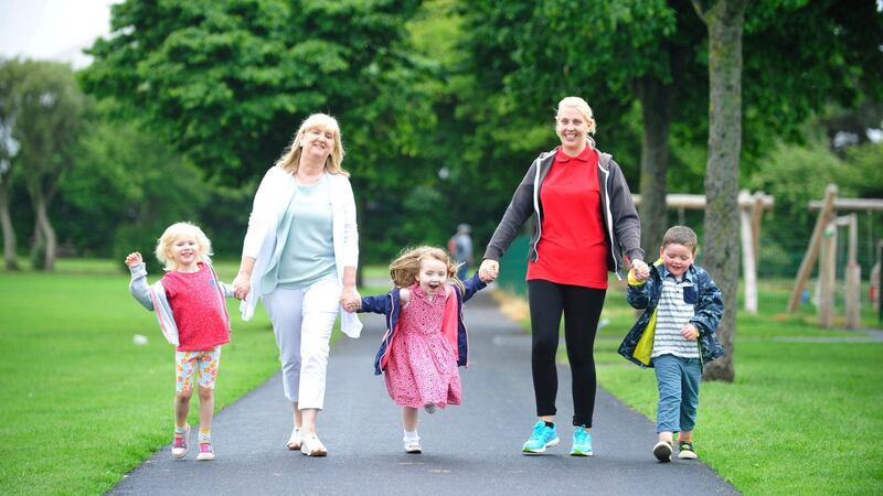 Lelia Murphy, left, manager of Crumlin Childcare Centre, and Lisa Cronin (right) with  Abbie Jordan, Katie Meade and Oliver Ryan in Pearce Park, in Crumlin on the way back from the public playground in the park. Photograph: Aidan Crawley