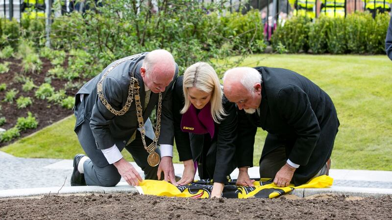 Dublin Lord Mayor Nial Ring (left), Helen McEntee TD, and Jan Peumans, speaker of the parliament of Flanders, burying soil from Flanders as a memorial to Irishmen who died there. Photograph: PA