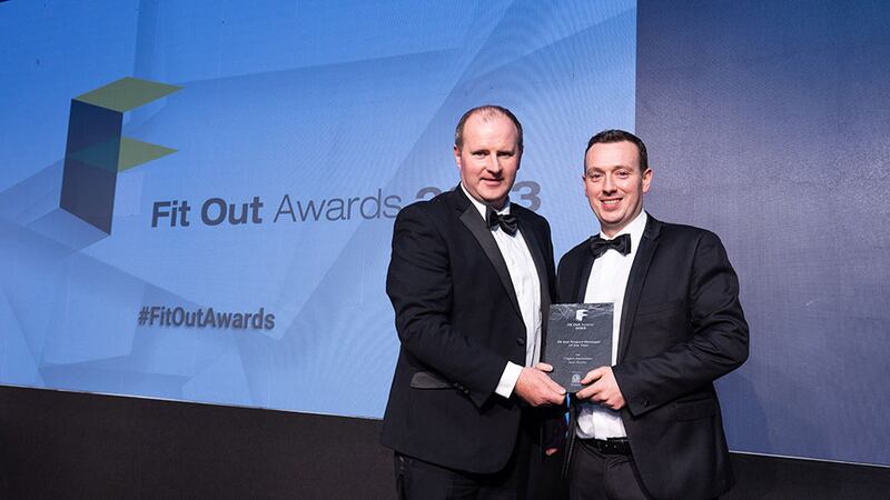 Pat Meade, presenting on behalf of Greenlam, presents the fit out manager of the year award to Glen Roche, Cogent Associates