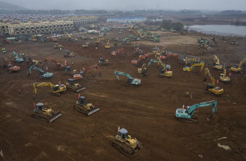 orkers driving excavators at the construction site of a field hospital in Wuhan, China. The builders will complete the 1,000-bed hospital by February 3rd to cope with the surge of the coronavirus in the city. Photograph: Getty Images