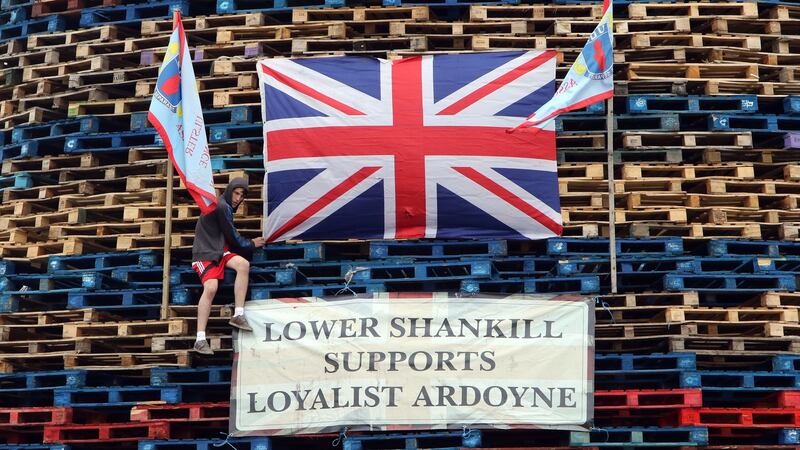 A boy fixes a flag onto a bonfire on the lower Shankill area of Belfast on July 11th, 2015. Photograph: Paul Faith/AFP via Getty Images