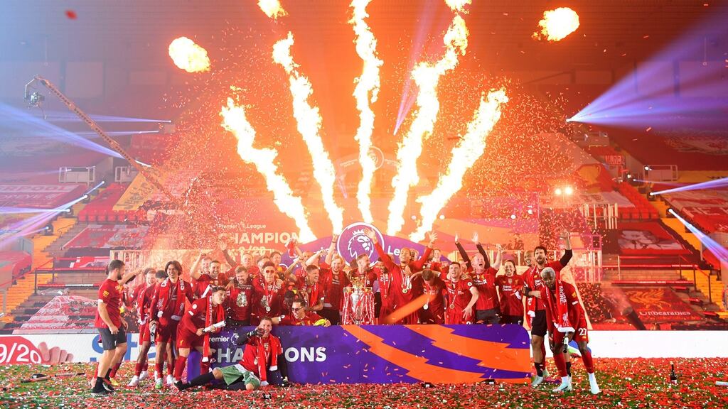 Liverpool players celebrate with the Premier League trophy at Anfield. Photo: Laurence Griffiths/Getty Images