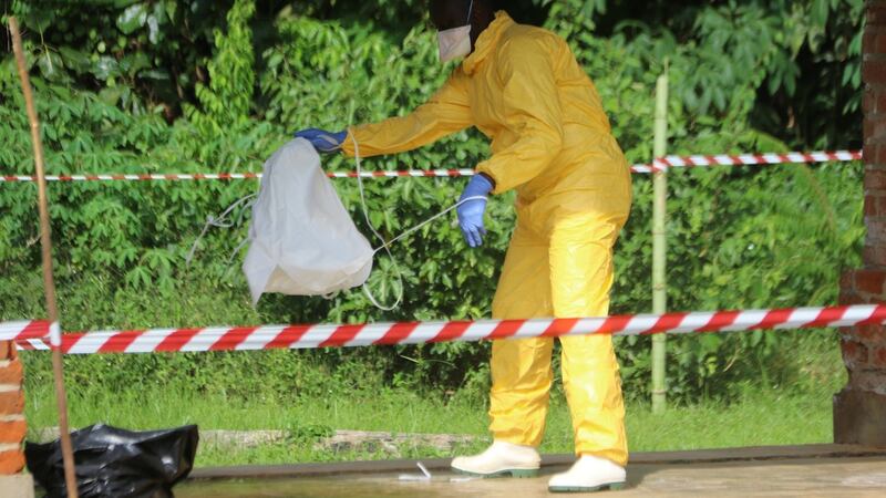 A health worker takes off protective clothing after visiting the isolation ward at Bikoro hospital, which received a new suspected Ebola case, in Bikoro, DRC. Photograph: Jean Robert N’Kengo/Reuters