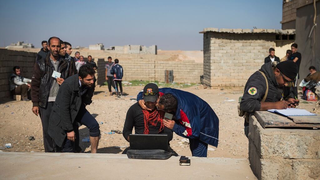 A man kisses a soldier from the Iraqi Special Forces 2nd division as they queue to have their ID checked. Photograph: Anderson Odd/Getty Images