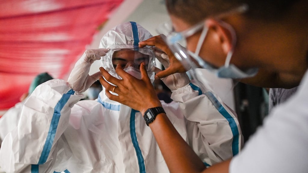 This photo taken on Monday shows a new volunteer wearing personal protective equipment as a preventive measure against the spread of the Covid-19 novel coronavirus, during a training session at a quarantine facilities centre in Yangon, Myanmar. Photograph: Ye Aung Thu/AFP/Getty Images