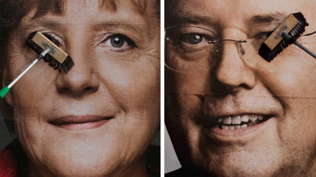 Workers paste up election posters of German chancellor Angela Merkel of the Christian Democratic Union and Peer Steinbrück of the Social Democratic Party. Photograph: Thomas Peter/Reuters