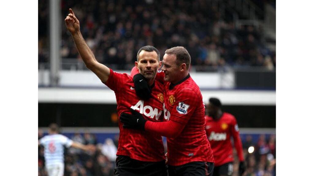 Manchester United's Ryan Giggs celebrates with team-mate Wayne Rooney after scoring his side's second goal of the game against QPR. Photograph: Nick Potts/PA Wire.